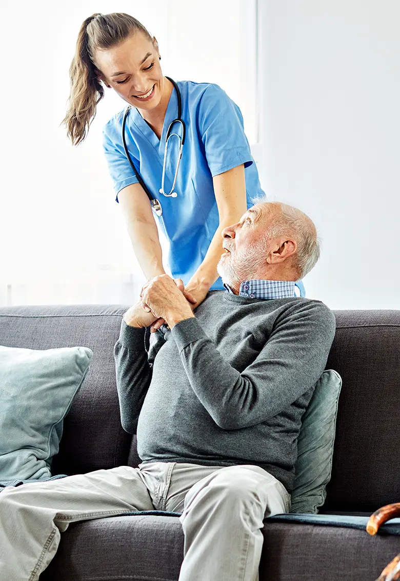 A nurse monitoring a patient’s blood sugar levels at home.