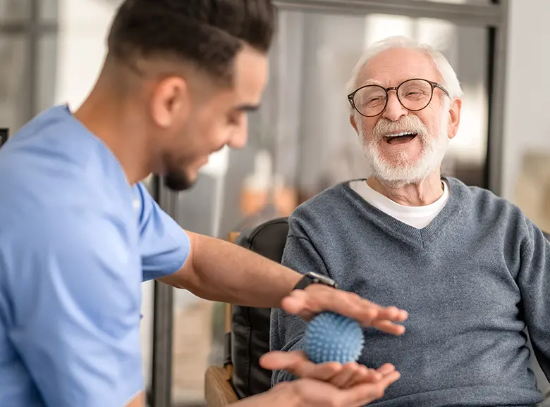 A caregiver assisting an elderly person with walking.