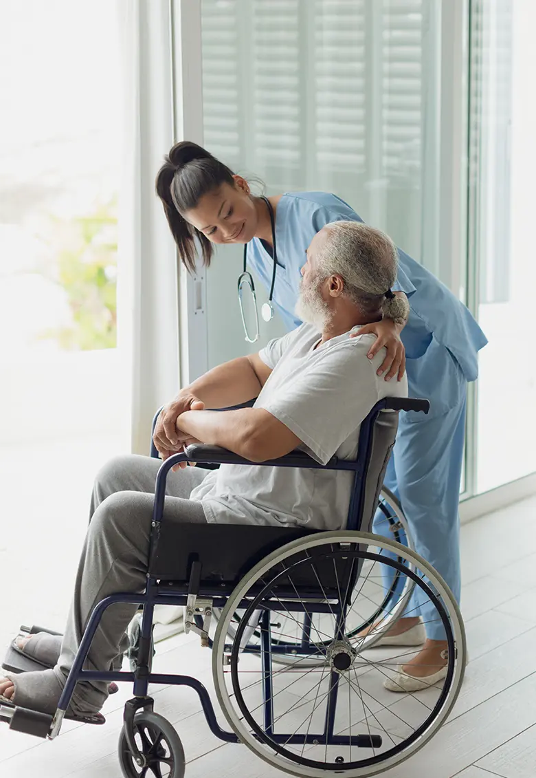 A physical therapist helping a senior with therapeutic exercises.